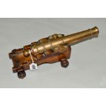 A BRASS DESK CANNON, mounted on wooden stand, length approximately 33cm (working order)