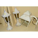 A WHITE PAINTED WROUGHT IRON WALL MOUNTED LANTERN together with a pair of pillar top lanterns (3)