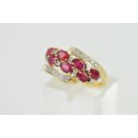 A 9CT GOLD RUBY AND DIAMOND RING, designed as two rows of four and three oval rubies interspaced