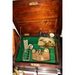 A STAINED WOODEN BOX, containing brass postal scales and weights, continental white metal vase,