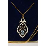 A TOPAZ, SEED PEARL AND ENAMEL PENDANT, of openwork design with central oval blue topaz, a seed