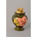 A MOORCROFT POTTERY TABLE TOP LIGHTER, Hibiscus pattern on green ground, impressed marks to base,