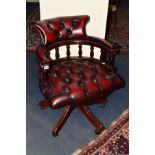 A REPRODUCTION BUTTONED OXBLOOD LEATHER OFFICE SWIVEL ARMCHAIR