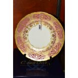 A BOXED ROYAL CROWN DERBY PLATE, A1359 'Heritage' pattern pink and lilac bands with gilt