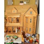 A THREE STOREY WOODEN DOLL'S HOUSE, with fitted interior porch, electrics for lighting, a separate