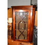 A MAHOGANY ASTRAGAL GLAZED HANGING CORNER CUPBOARD (key) a modern gout stool and another stool (3)