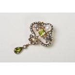 A PERIDOT, SEED PEARL AND DIAMOND BROOCH, of openwork, scrolling and foliate design, set with a