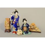 TWO EARLY 20TH CENTURY JAPANESE PORCELAIN FIGURES OF GEISHAS, wearing blue kimonos, polychrome