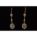 A PAIR OF EMERALD AND DIAMOND DROP EARRINGS, each designed as a floral emerald and diamond set panel