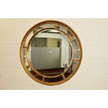 A REPRODUCTION FOLIATE GILT FRAMED CIRCULAR BEVELLED EDGE WALL MIRROR, diameter 112cm