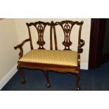 A REPRODUCTION MAHOGANY CHIPPENDALE STYLE TWO SEATER SOFA, with gold upholstered drop in seat pad on