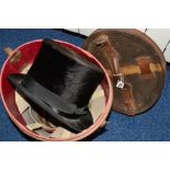 A LEATHER HAT BOX, containing a Perkin Brothers Hatters & Co, Plymouth black top hat