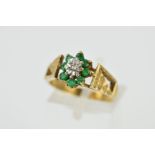 A 9CT GOLD EMERALD AND DIAMOND CLUSTER RING, designed as a central single cut diamond within an