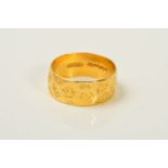 A 22CT BAND RING, designed as a flat band with textured patches, width 8mm, ring size P, weight 5.