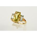 A 9CT GOLD GEM RING, designed as a central rectangular citrine within a four claw setting, flanked