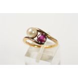 A RUBY AND CULTURED PEARL TWO STONE CROSS OVER RING, a round mixed cut ruby measuring