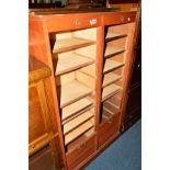 AN OAK DOUBLE SIDED ROLL FRONT CABINET, width 83cm x depth 36cm x height 47cm (key)