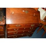 AN EARLY 20TH CENTURY GEORGIAN STYLE OAK AND BANDED FALL FRONT BUREAU revealing a fitted interior