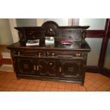 AN EARLY 20TH CENTURY CARVED OAK SIDEBOARD, of geometric form, with a raised back flanked by bulbous