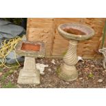 A COMPOSITE BIRD BATH WITH CIRCULAR TOP, together with another bird bath with a decorated base and