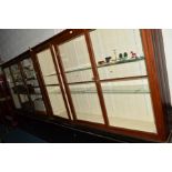 A PAIR OF MAHOGANY THREE DOOR DISPLAY CABINETS, painted interior with double glass shelves and