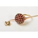 A 9CT GOLD GARNET DRESS RING AND A STICKPIN, the ring designed as a domed panel set with circular