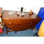 A REPRODUCTION OAK OVAL TOPPED GATE LEG TABLE