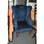 A BLUE UPHOLSTERED WING BACK ARMCHAIR