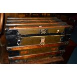 A VINTAGE WOODEN AND METAL BANDED TRAVELLING TRUNK, bearing various travel labels, width 82cm x