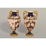 A PAIR OF ROYAL CROWN DERBY IMARI TWIN HANDLED VASES, numbers to base 1238 and 6299, heights