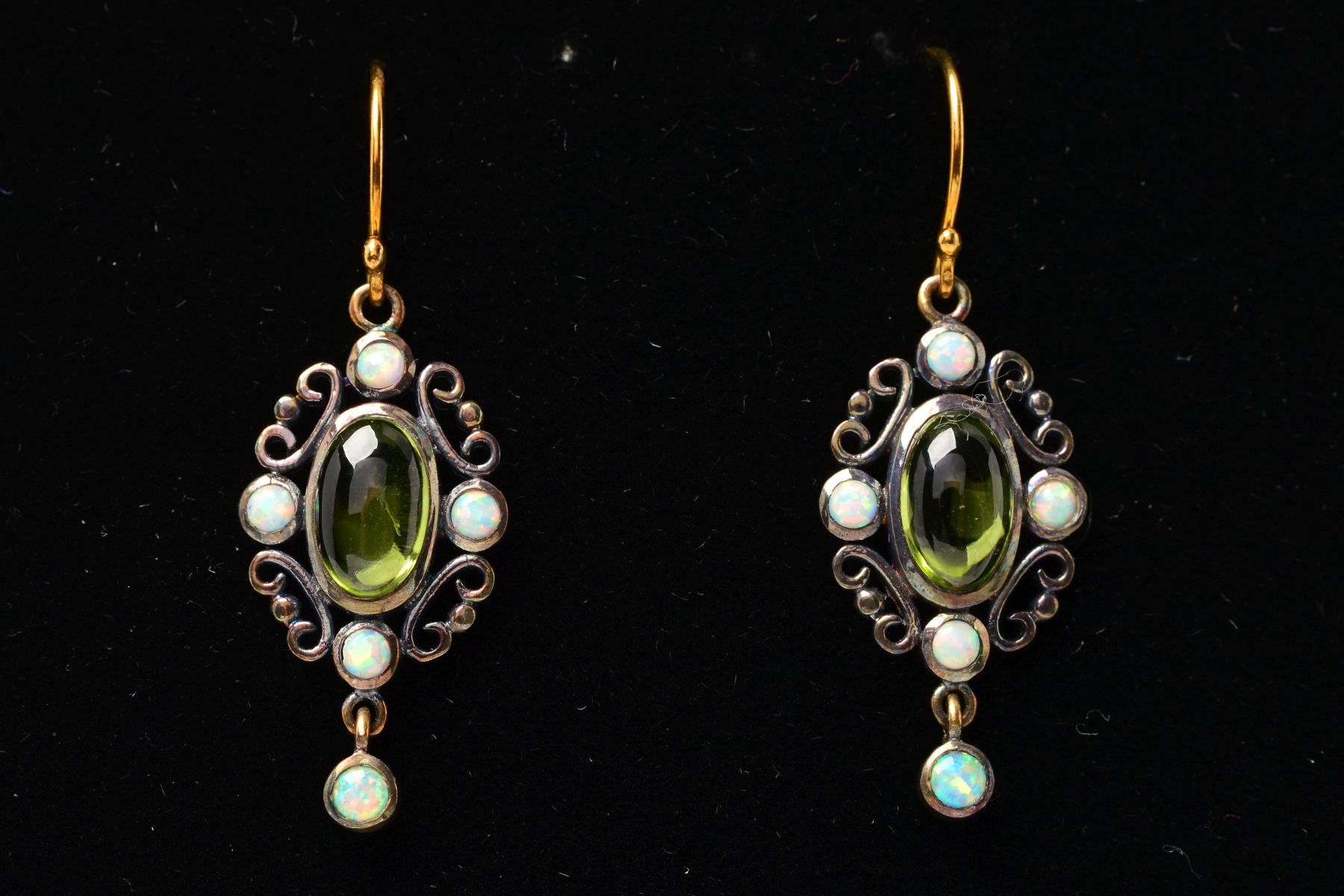 A PAIR OF PERIDOT AND OPAL PENDANT EARRINGS, each designed as a central oval peridot cabochon within