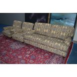 A MULTIYORK UPHOLSTERED GOLD, STRIPPED AND FLORALLY DECORATED THREE PIECE LOUNGE SUITE, on turned