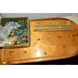A TIN OF MARBLES, various sizes and colours, together with a bagatelle (sd) and a bagatelle