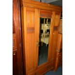 AN EDWARDIAN ASH TWO PIECE BEDROOM SUITE, comprising a single mirror door wardrobe above a single