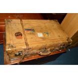 A VINTAGE LEATHER SUITCASE, with travel labels and straps, width 77cm x depth 45cm x height 24.5cm