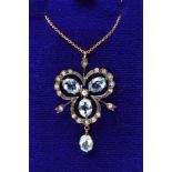 A TOPAZ AND DIAMOND PENDANT NECKLACE, designed as a trefoil of three oval blue topaz gems within