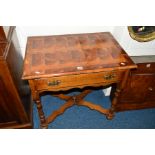 A REPRODUCTION OAK LOWBOY, with a multi wood specimen geometric top, single drawer, raised on turned
