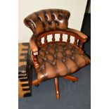 A REPRODUCTION BUTTONED BROWN LEATHER SWIVEL ARMCHAIR, (missing one caster)