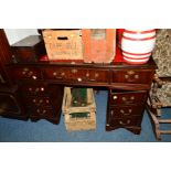 A REPRODUCTION MAHOGANY PEDESTAL DESK, the top with red tooled leather inlay, fall front door