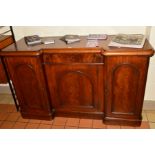 A VICTORIAN FLAME MAHOGANY THREE DOOR SIDEBOARD, the flanked cupboard doors revealing various