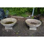 A LARGE PAIR OF CIRCULAR COMPOSITE PLANTERS with columned perimeter on a separate square base,
