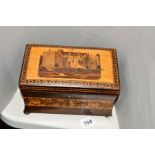 A TUNBRIDGE WARE TEA CADDY, with building and floral inlaid decoration, waisted body and bun feet,