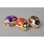 THREE ROYAL CROWN DERBY PAPERWEIGHTS, 'Ladybird' (seven spots) light gold stopper, 'Blue