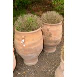 A PAIR OF LARGE TERRACOTTA AMPHORA SHAPED GARDEN URNS with triple hooped handles, height 89cm x