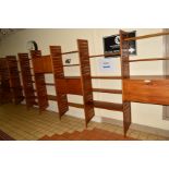 A STAPLES LADDERAX NINE SECTION WALL SHELVING SYSTEM, comprising eight tall wooden laddered