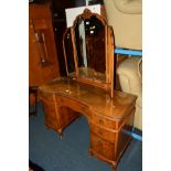 A REPRODUCTION BURR WALNUT TWIN PEDESTAL DRESSING TABLE with a triple mirror and nine various