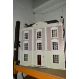 A THREE STOREY DOLLS HOUSE, containing some furniture and electrics, height 87cm x width78cm x depth