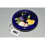 A MOORCROFT POTTERY LIPPED DISH, 'Wisteria' pattern on blue ground, impressed marks to base,