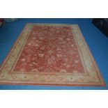 A MODERN WOOLLEN CARPET SQUARE, red and russet ground with foliate decoration, approximately 301cm x