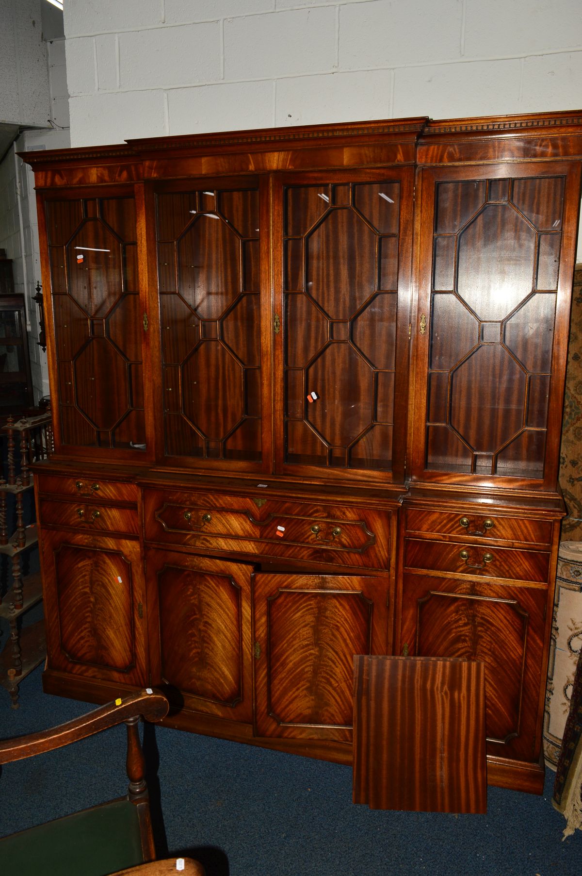 A BEVAN FUNNELL REPRODUX FLAME MAHOGANY BREAKFRONT SECRETAIRE BOOKCASE, the top with four glazed